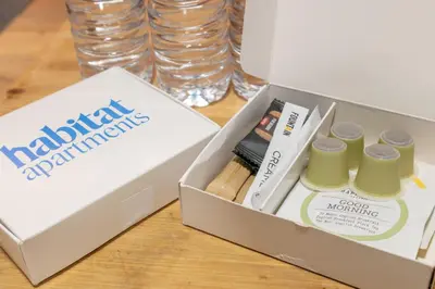 a box with a pack ofmatching products on a table at Habitat Apartments Arenas Parc in Barcelona