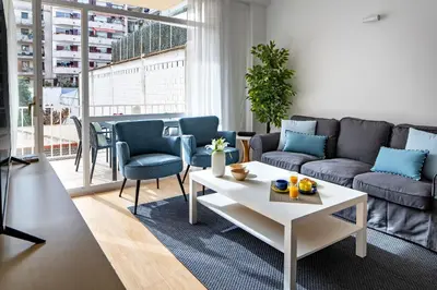 a living room with a couch and a table at Habitat Apartments Arenas Parc in Barcelona