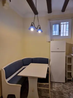 a living room with a couch and a table and a refrigerator at 2 bedrm BCN down AC WIFI 30 nigths min in Barcelona