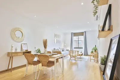 a dining room and living room with a table and chairs at Ola Living Consell De Cent in Barcelona