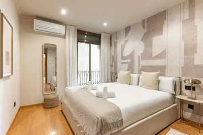 a bedroom with a large white bed in a room at Ola Living Consell De Cent in Barcelona
