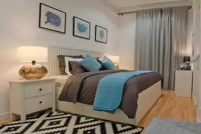 a bedroom with a bed and a night stand with a lamp at Way to BCN Casa Rovira in Barcelona