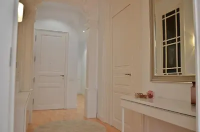 a hallway with a white door and a mirror at Way to BCN Casa Rovira in Barcelona