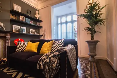 a living room with a couch and a plant at Way to BCN Casa Rovira in Barcelona