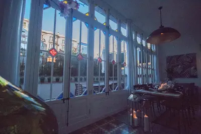a room with a large window with a table in front at Way to BCN Casa Rovira in Barcelona