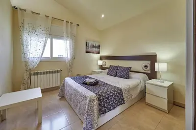 a bedroom with a bed and a window at Villa ilusions en Olivella, Sitges, Barcelona in Olivella
