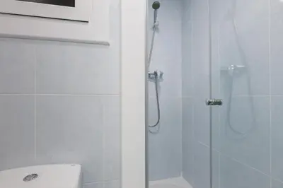 a bathroom with a shower and a toilet and a sink at Housalia Gracia 2 in Barcelona