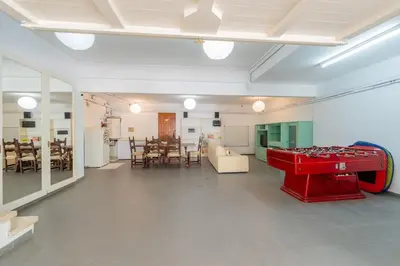 a living room with a red table in the middle at Casa Farré next Barcelona Center in Pallejá