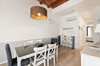 a kitchen and dining room with a table and chairs at Enjoy Apartments Montserrat Boutique Apartment in Eixample in Barcelona