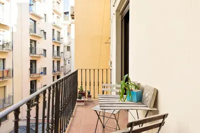 a balcony with a table and a potted plant at Enjoy Apartments Montserrat Boutique Apartment in Eixample in Barcelona