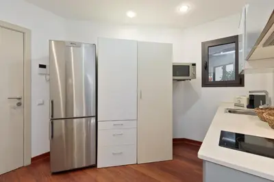 a kitchen with a stainless steel refrigerator at Enjoy Apartments Urban Retreat Valencia 2 in Barcelona