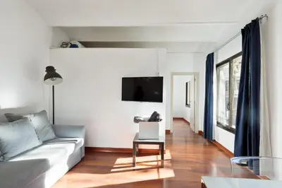 a living room with a couch and a tv at Enjoy Apartments Urban Retreat Valencia 2 in Barcelona