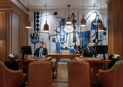 two men sitting at tables in a conference room at H10 Metropolitan 4* Sup in Barcelona