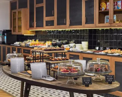 a bakery with a display of pastries on a table at H10 Metropolitan 4* Sup in Barcelona