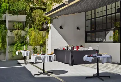 two tables with food on them in a courtyard at H10 Metropolitan 4* Sup in Barcelona