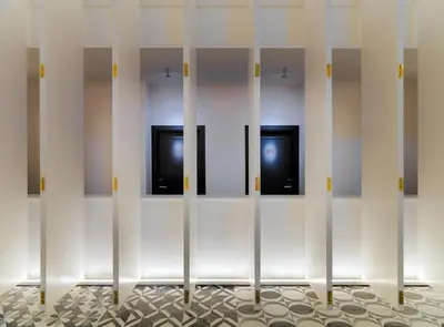 a locker room with four doors in a wall at H10 Metropolitan 4* Sup in Barcelona