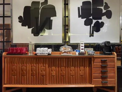 a counter in a restaurant with black and white posters at H10 Metropolitan 4* Sup in Barcelona