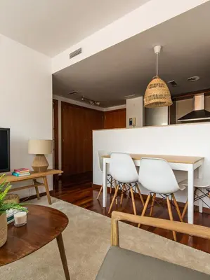 a living room with a table and white chairs at Homing Barcelona 101 in Hospitalet de Llobregat