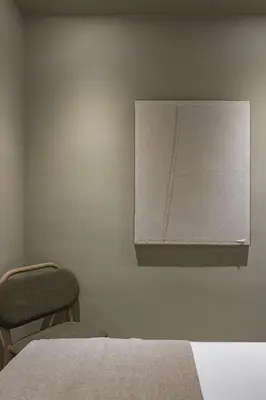 a bedroom with a bed and a chair and a cabinet at Ola Living Hostal Diagonal in Barcelona