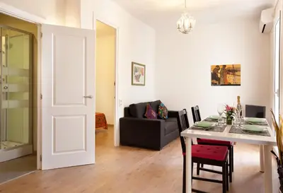a living room with a table and a couch at Centric Apartment El Molino Theater p1 in Barcelona