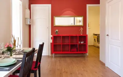 a red dining room with a table and a red wall at Centric Apartment El Molino Theater p1 in Barcelona