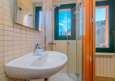 a bathroom with a sink and a glass shower at Cal Metge de Gualba in gualba de Dalt