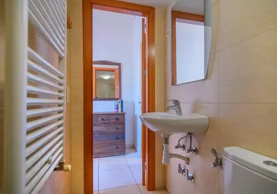 a bathroom with a sink and a toilet and a mirror at Cal Metge de Gualba in gualba de Dalt