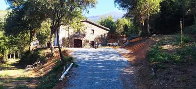 a road in front of a house with a building at Masia Casa Nova de n'Illa in Montseny