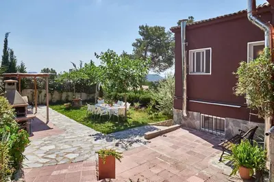 a patio of a house with a table in the yard at Villa Soledad en Olivella, Sitges, Barcelona in Olivella
