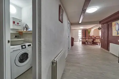 a kitchen with a washing machine and a dining room at Villa Soledad en Olivella, Sitges, Barcelona in Olivella
