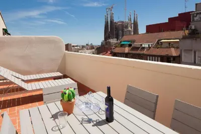 a bottle of wine sitting on a table on a roof at Ola Living Sagrada Familia in Barcelona