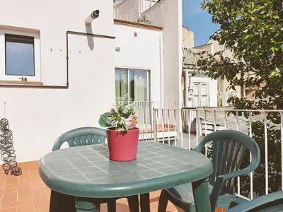 a green table with a potted plant on a balcony at Apartamento nuevo en Terrassa Centro in Terrassa