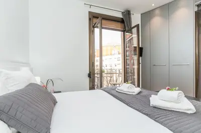 a bedroom with a white bed with towels on it at Housalia Sant Pau Views- Suite with View on Hospital Sant Pau in Barcelona