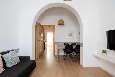 a living room with a couch and a table at Housalia Lepant 3 bedroom apartment 300 meters de Sagrada Familia in Barcelona