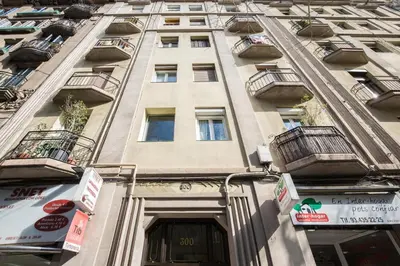 a tall building with balconies on the side of it at Housalia Lepant 3 bedroom apartment 300 meters de Sagrada Familia in Barcelona