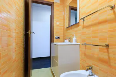 a bathroom with a toilet and a sink and a mirror at Housalia Corsega - Apartment 3 bedrooms next to Sagrada Familia in Barcelona