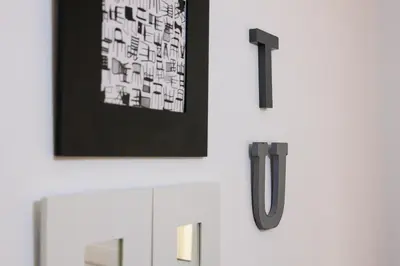 a room with white furniture and a picture on the wall at Housalia Corsega - Apartment 3 bedrooms next to Sagrada Familia in Barcelona