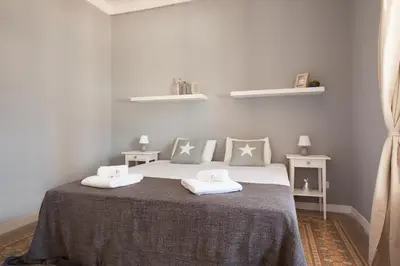 a bedroom with a bed with two pillows on it at Enjoy Apartments Sofia in Barcelona