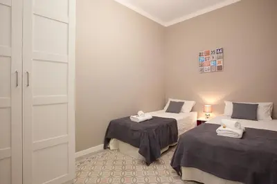 a small room with two beds and a closet at Enjoy Apartments Sofia in Barcelona
