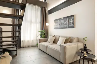 a living room with a couch and a staircase at Ola Living MACBA in Barcelona