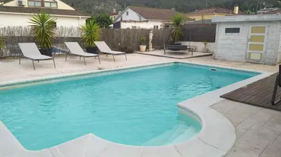 a swimming pool with chairs in a yard at Villa Franz House Casa Principal in Canyelles
