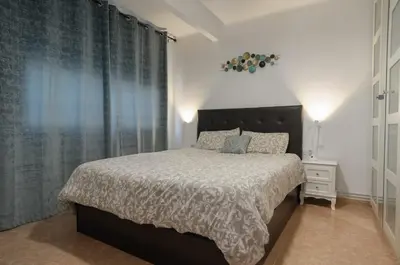 a bedroom with a bed and a large window at Apartamento al lado Del Mar in Sant Adria de Besos