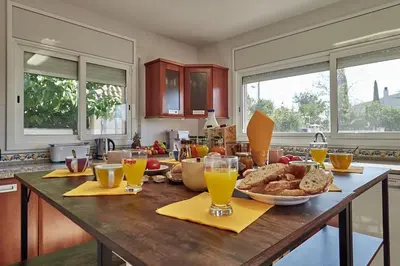 a kitchen with a table full of food and drinks at Villa lluna en Olivella, Sitges, Barcelona in Olivella