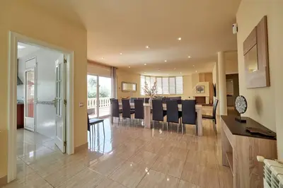 a kitchen and dining room with a table and chairs at Villa lluna en Olivella, Sitges, Barcelona in Olivella