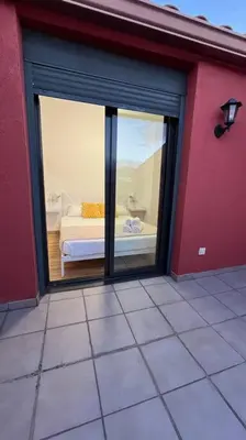 a room with a view of a bedroom with a window at Dúplex con terraza by Prestigi in Terrassa