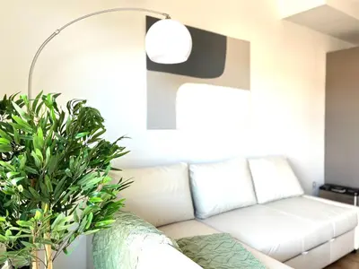 a living room with a white couch and a lamp at Dúplex con terraza by Prestigi in Terrassa