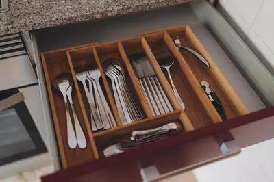 a wooden drawer filled with utensils in a kitchen at The Orbit Apartments in Barcelona