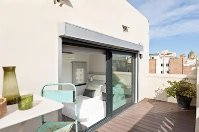an open sliding glass door on a balcony at Enjoy Apartments La Riera Penthouse in Barcelona