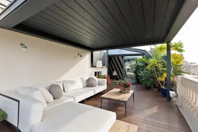 a living room with white couches on a balcony at Enjoy Apartments La Riera Penthouse in Barcelona