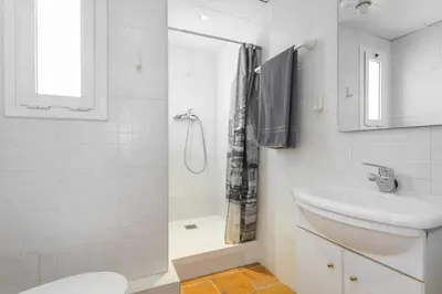 a bathroom with a toilet and a sink and a shower at ApartEasy - Lightly, central and quiet apartment in Barcelona
